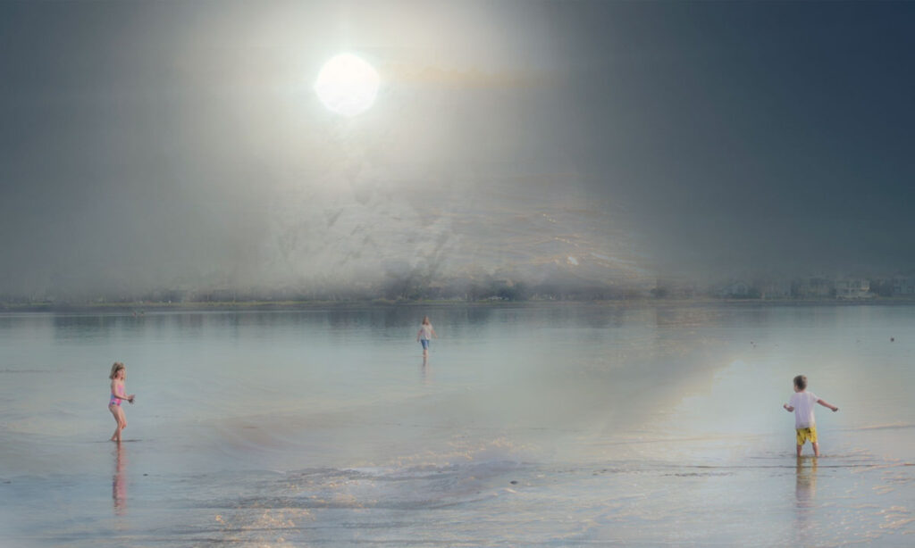 two children with woman playing in the sea