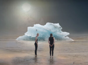 two men standing by an iceberg