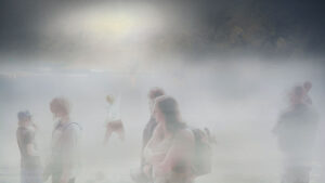 people walking in a misty environment